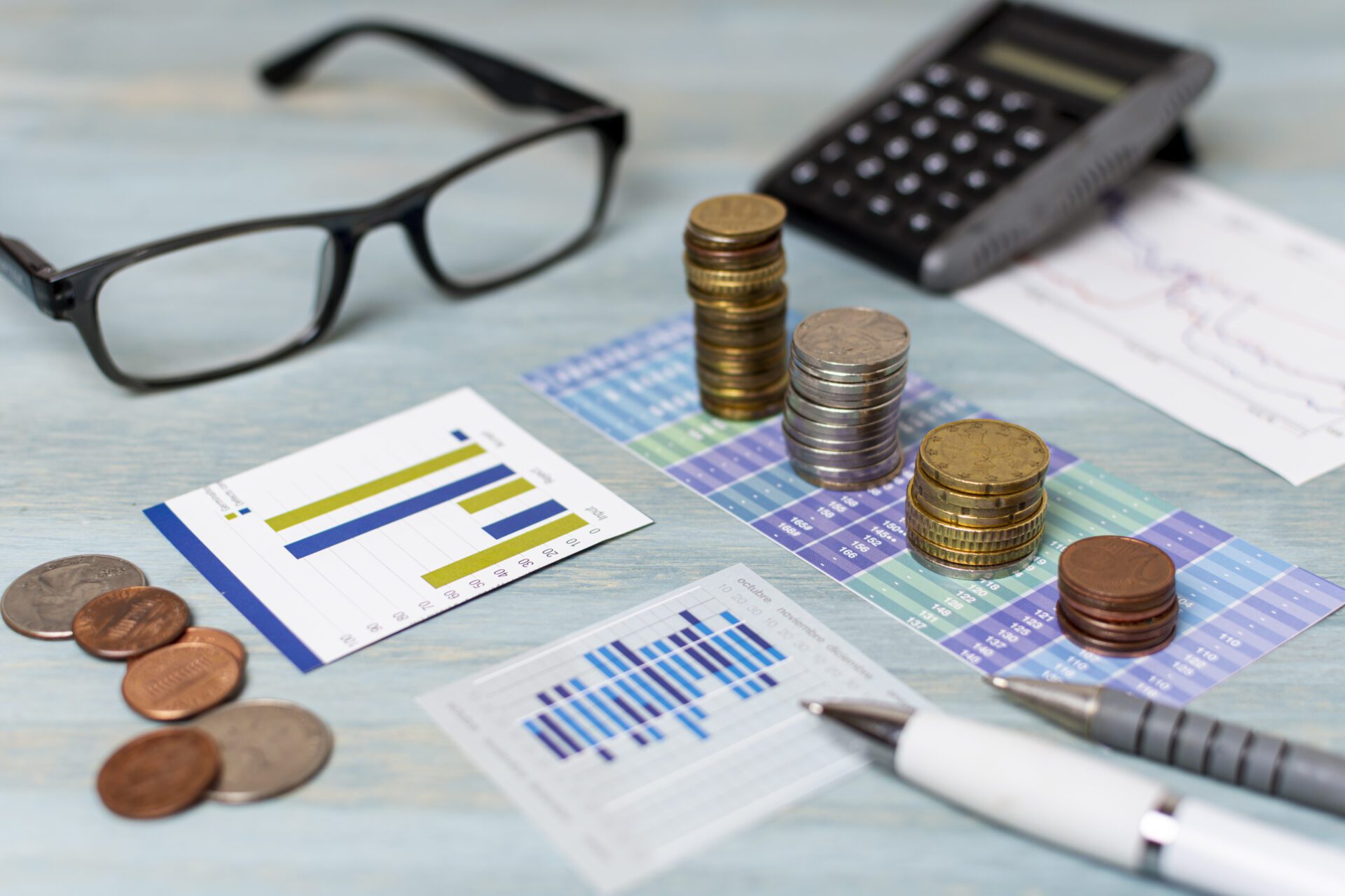 reading-glasses-piles-coins-high-view